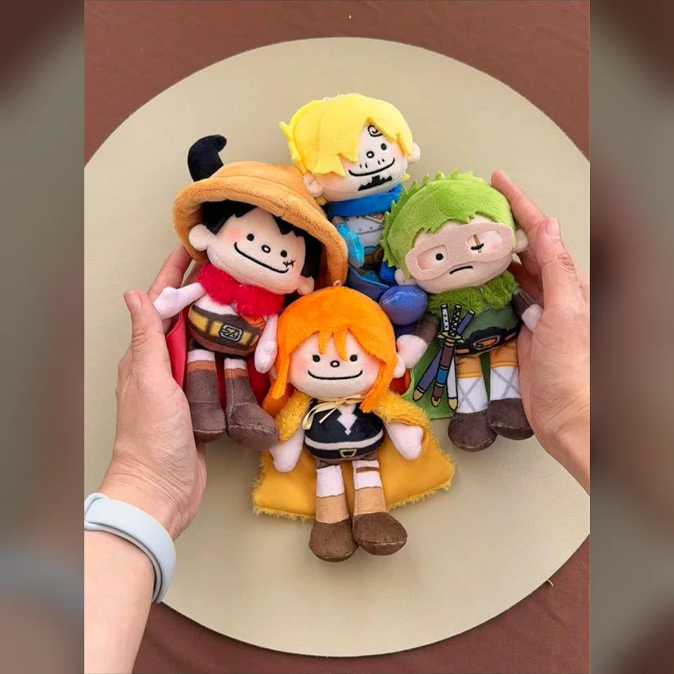 Four One Piece plush toys held in two hands to show their real size